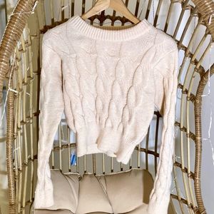 Cream cable knit sweater.